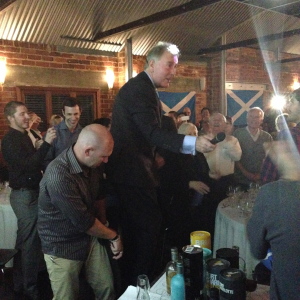 Jim holding court and leading the room in a boisterous version of the Scottish national anthem